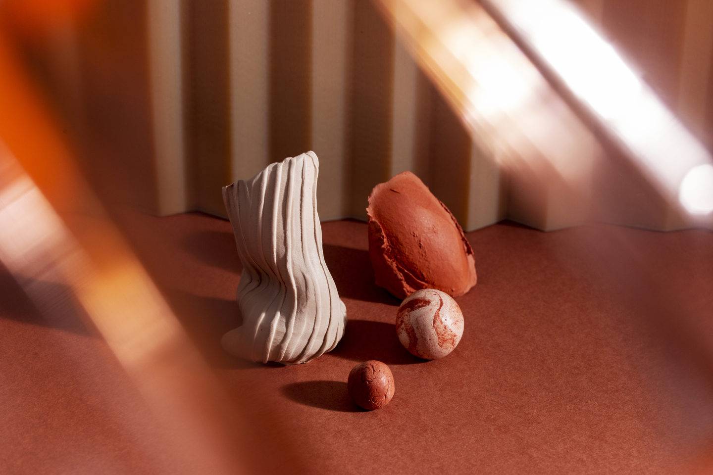 3D materials in interesting shapes and textures in shades of cream and coral