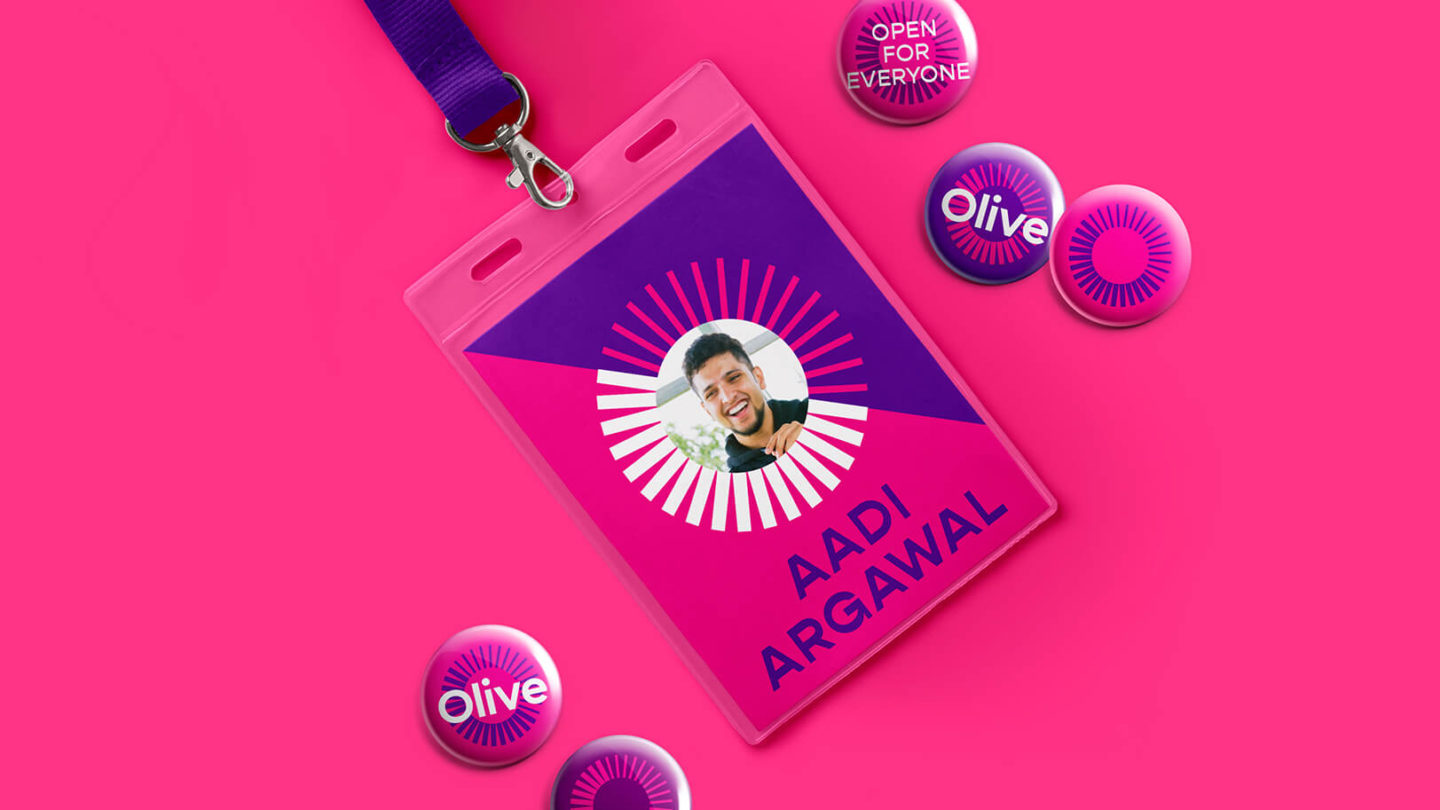 An employee badge with the Olive brand. A photo of the employee and his name Aadi Argawal can be seen on the badge