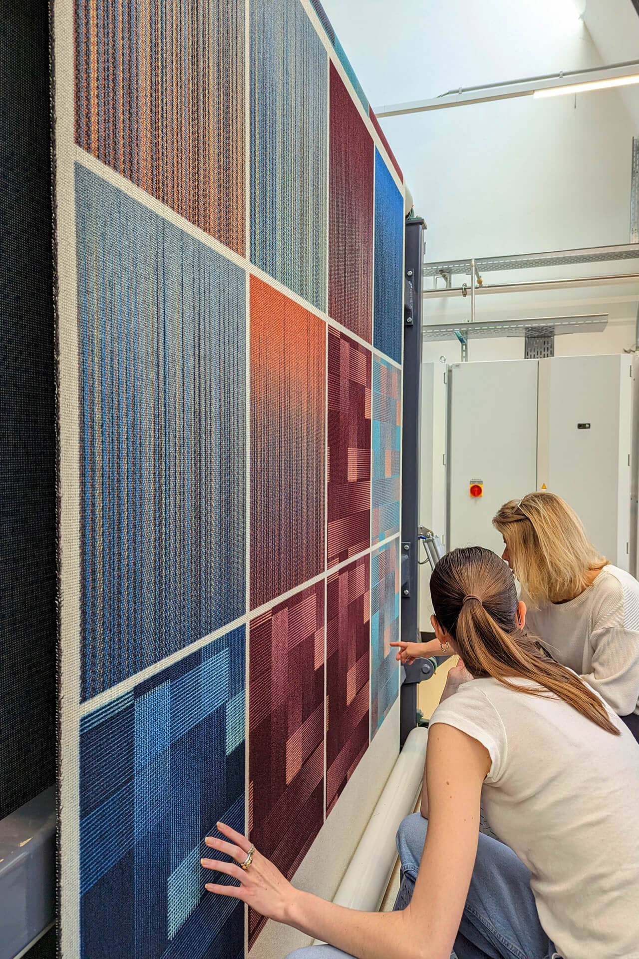 PG team looking at details of the carpet during production