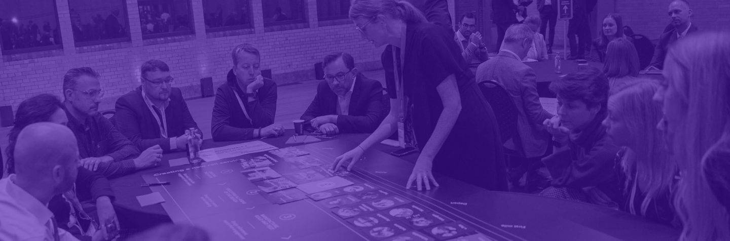 A group of people in discussion around a table