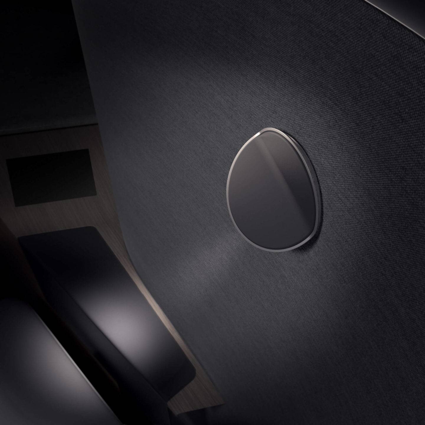 Small round reading light on a dark grey surface