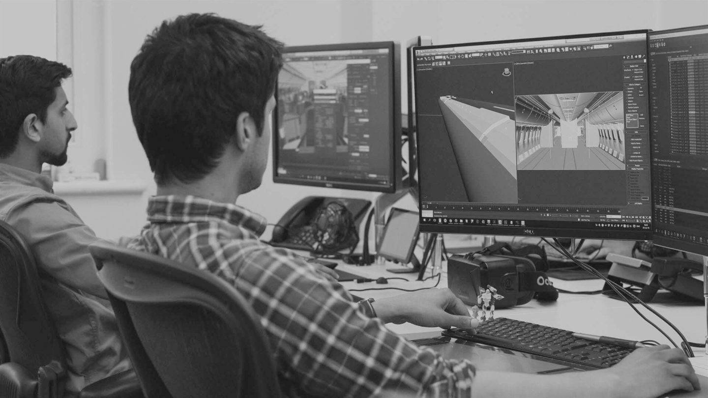 Two people working at their computers