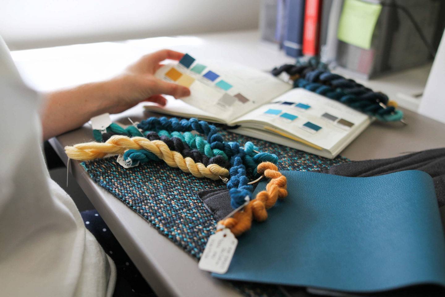 A designer looking at colour, material and finish samples